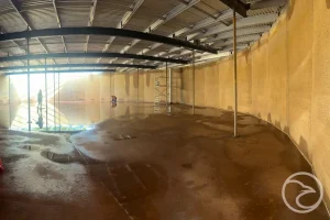 specialist assessing tank interior for defects